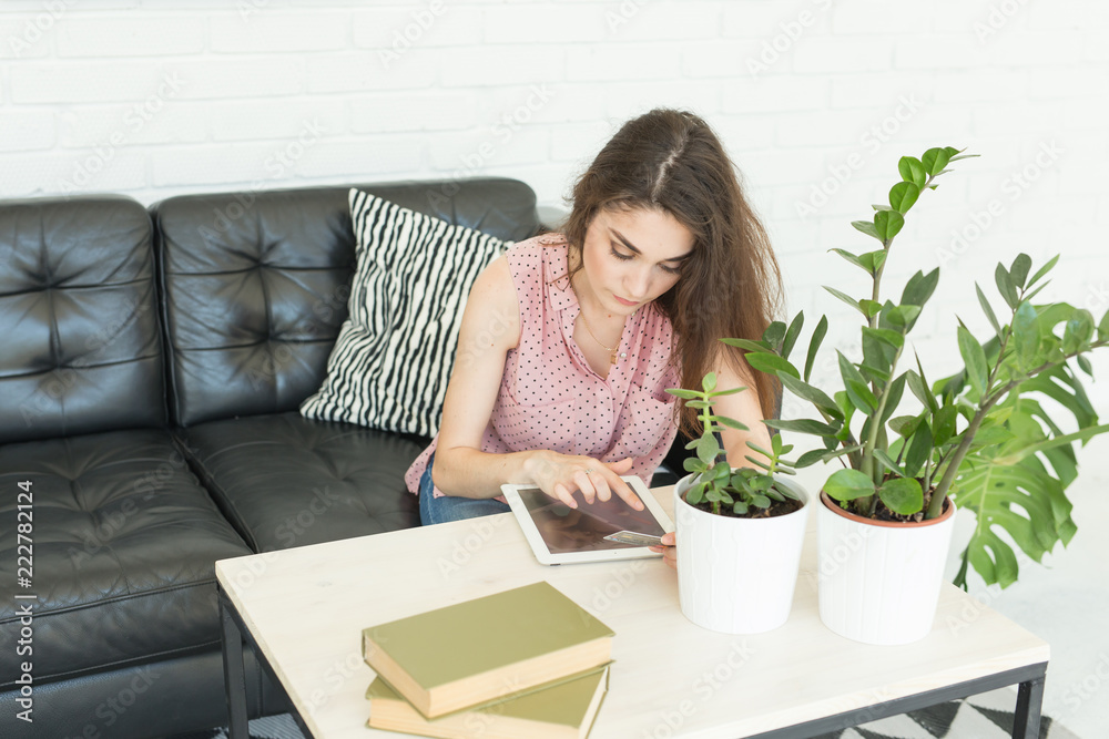 Cyber monday and black Friday concept - Young woman online shopping using tablet and credit card in livingroom Cyber monday and black Friday concept - Young woman online shopping using tablet and credit card in livingroom