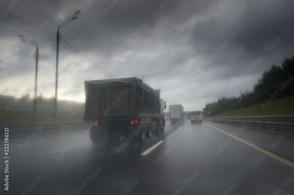 truck on wet asphalt after rain. Dark clouds on the sky truck on wet asphalt after rain. Dark clouds on the sky