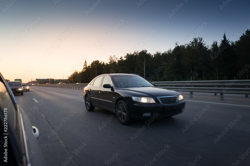 Highway transportation with cars during the sunset
