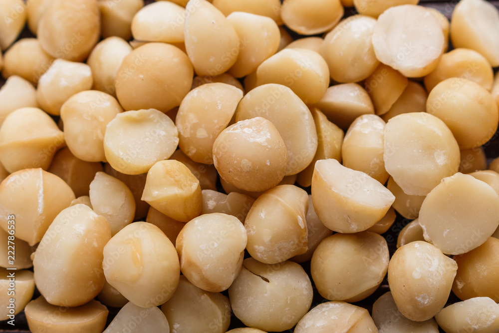 delicious macadamia nuts on a wooden rustic background delicious macadamia nuts on a wooden rustic background