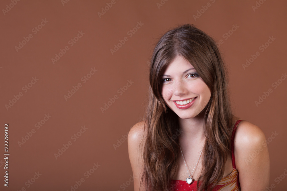 Naturally thin healthy brunette girl in the studio with a brown background Naturally thin healthy brunette girl in the studio with a brown background