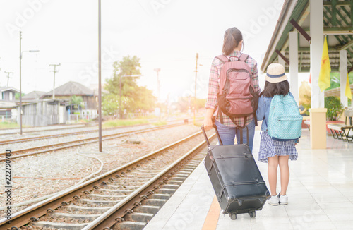 woman pull black leather vintage bag with kid