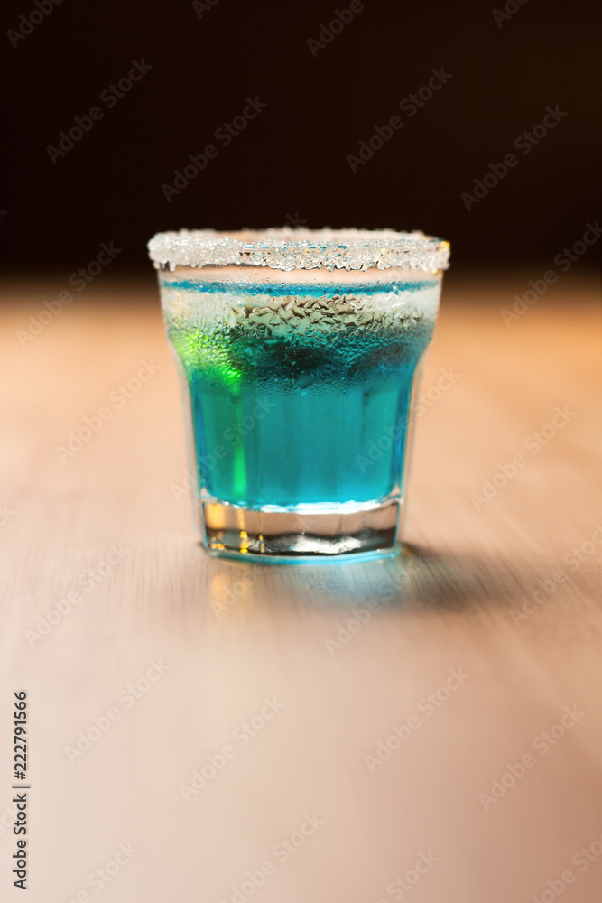 blue shot on bar with black background