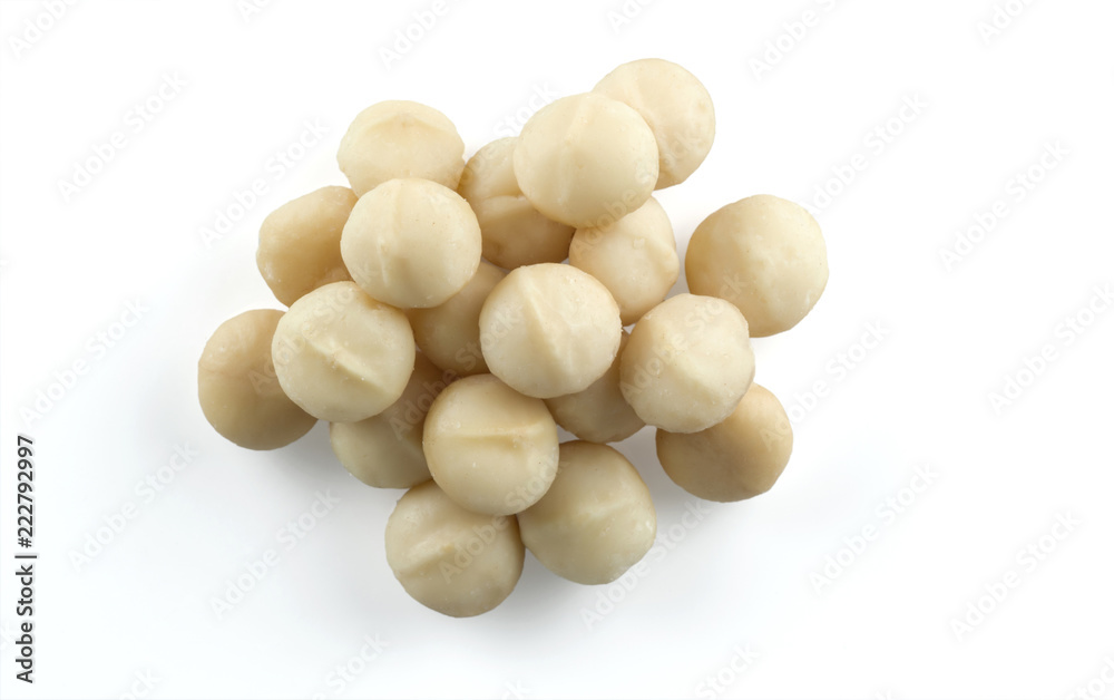 A handful of macadamia nuts isolated on white background. A handful of macadamia nuts isolated on white background.