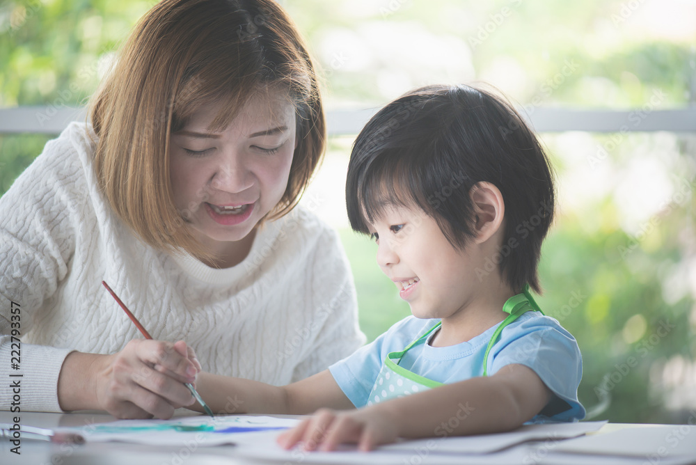 Asian child and mother painting together Asian child and mother painting together