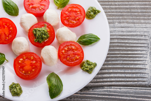 Caprese salad on a wooden rustic background