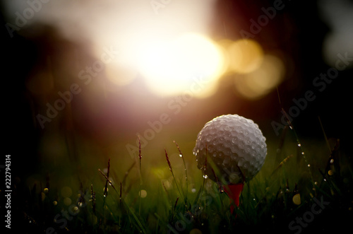 Golf ball with warm sunlight and raining at sunset