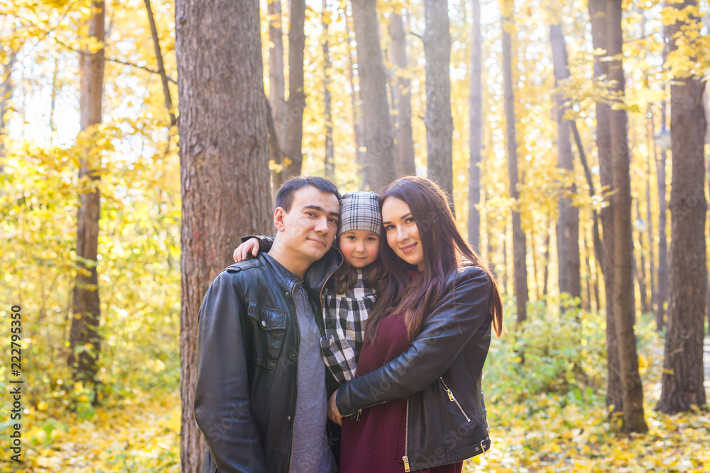 People, family and leisure concept - family standing in autumn park having fun People, family and leisure concept - family standing in autumn park having fun