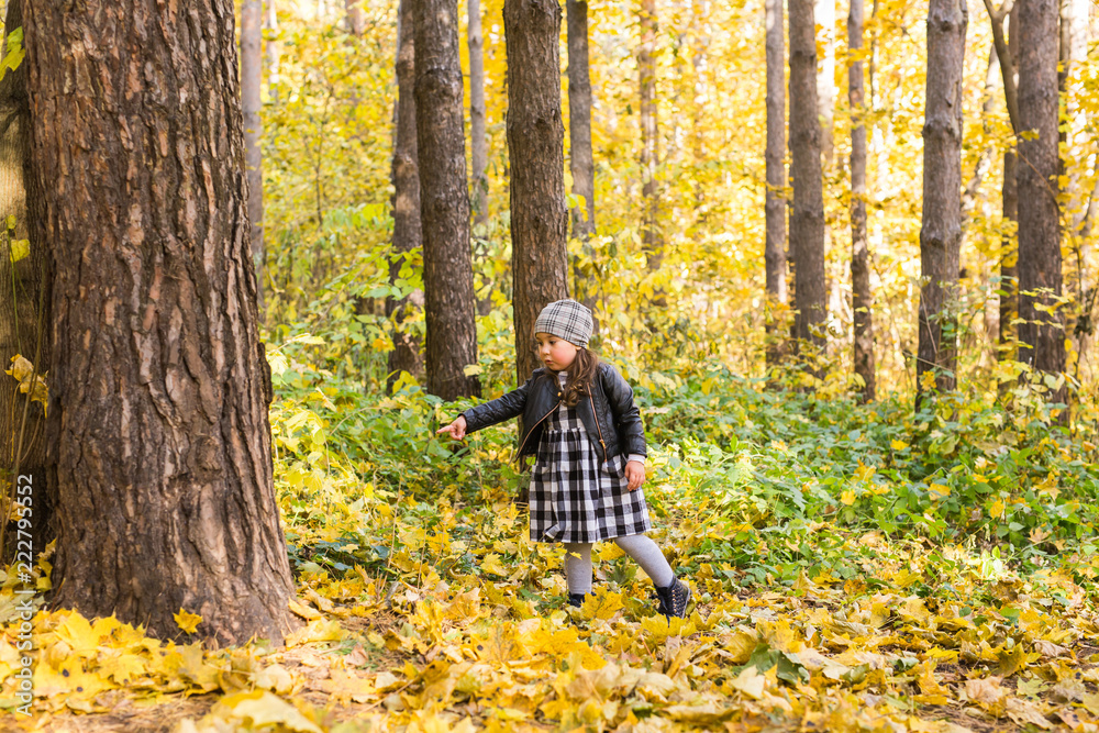 Childhood, autumn and family concept - happy little child playing in the park Childhood, autumn and family concept - happy little child playing in the park