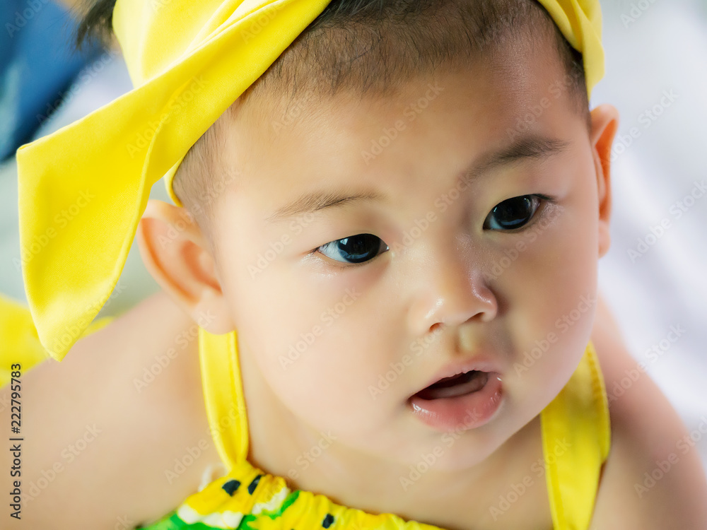 Portrait of cute short hair asia baby girl in color full wearing frowned  and look something Stock Photo | Adobe Stock
