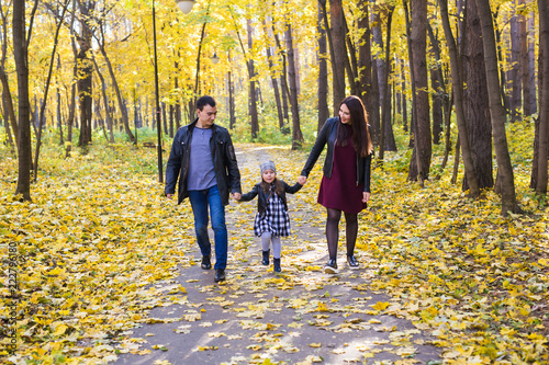 Parks, nature and family concept - Happy family walking in autumn park