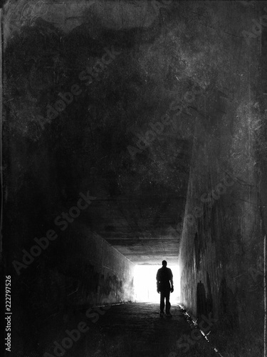 Silhouette of a man stood in a tunnel