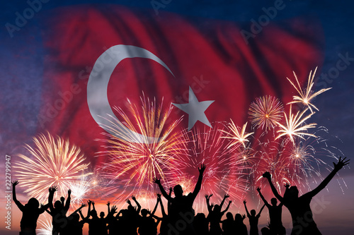 People are looking on fireworks and flag of Turkey