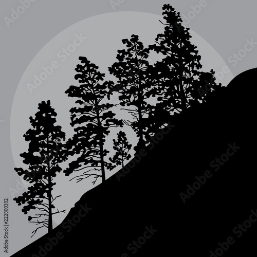 painted silhouette of trees on a mountainside in a gray sky