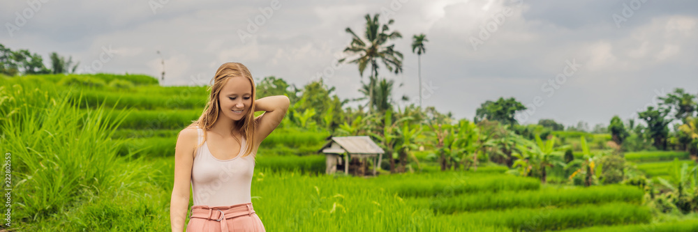 Young woman traveler on Beautiful Jatiluwih Rice Terraces against the background of famous volcanoes in Bali, Indonesia BANNER, long format Young woman traveler on Beautiful Jatiluwih Rice Terraces against the background of famous volcanoes in Bali, Indonesia BANNER, long format