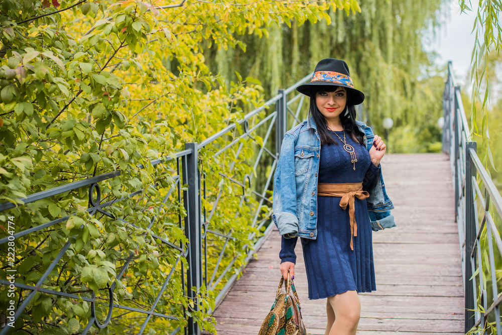 Fall, nature and people concept - Young beautiful woman with dark hair have a rest in autumn time. Pretty nice woman traveler is relax. Enjoying at day, concept adventure stylish vacations outdoor  