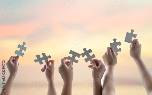 Teamwork idea brainstorming, team partnership connection for problem solving, finding solution in hope concept with puzzle pieces in school children or student kids's hands