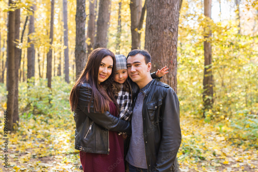 Fall, nature and family concept - Portrait of happy family over autumn park background Fall, nature and family concept - Portrait of happy family over autumn park background