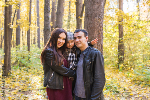 Fall, nature and family concept - Portrait of happy family over autumn park background © satura_