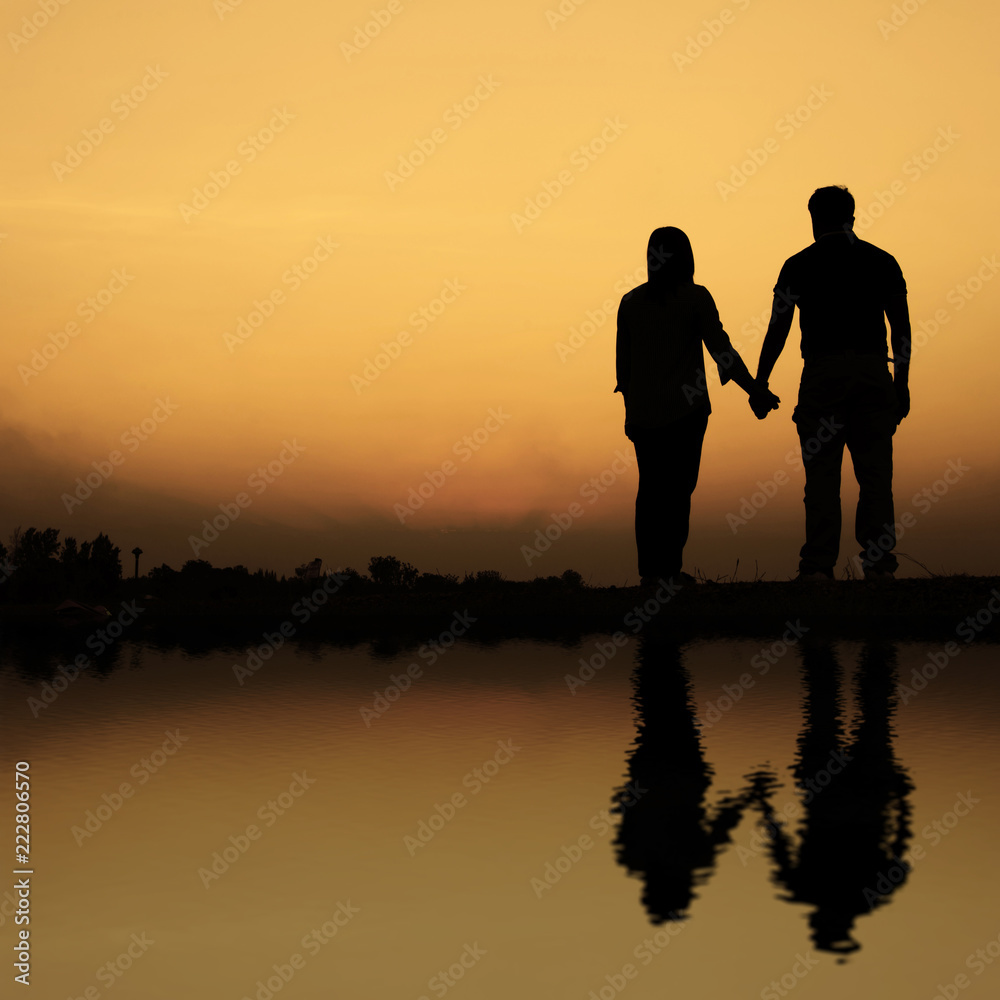 silhouette of couple on the beach at sunset silhouette of couple on the beach at sunset