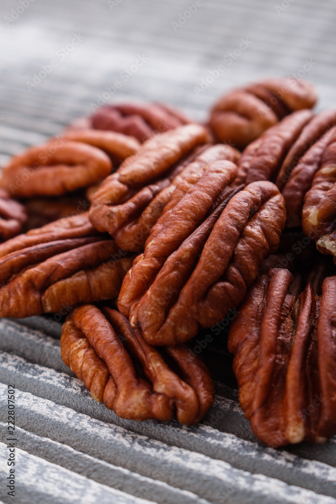 delicious pecan nuts on a rustic wooden background