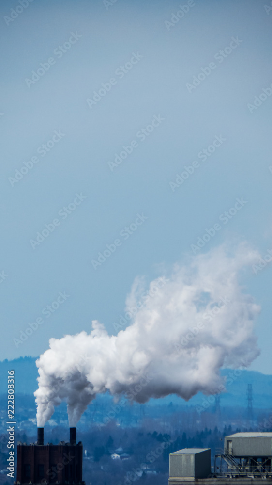 Vertical photo - Smoke/Vapor cloud going out of an industrial building from Quebec City, Canada.