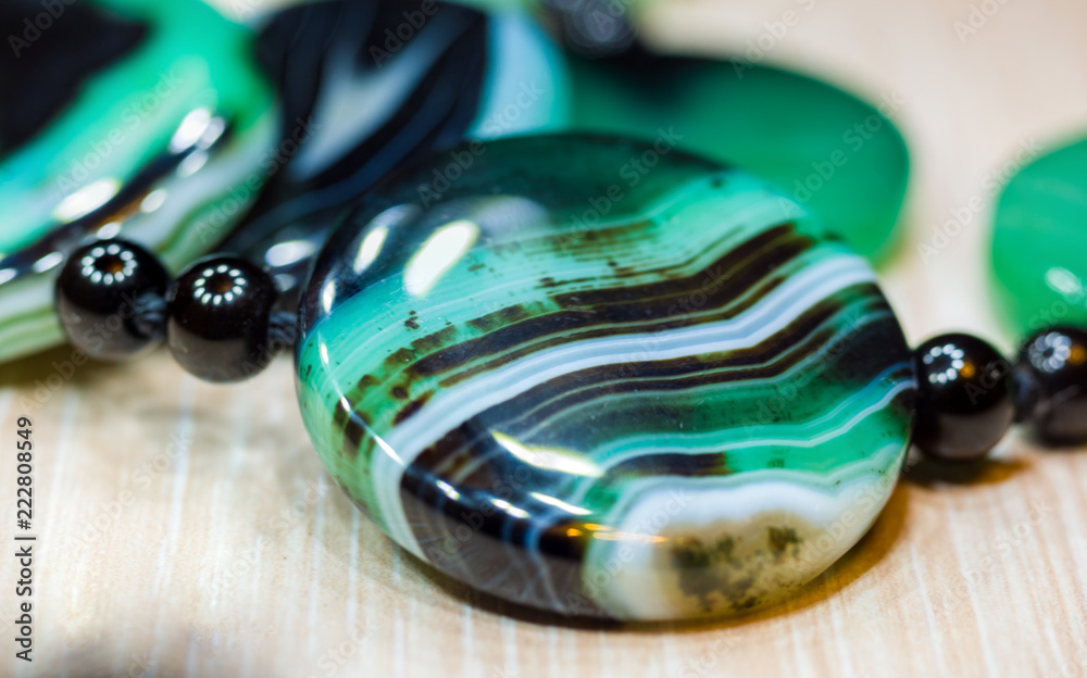 Large polished beads of beautiful translucent green agate gemstone, macro Large polished beads of beautiful translucent green agate gemstone, macro