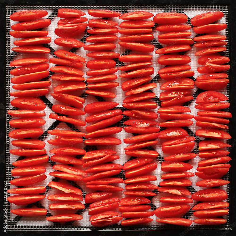 sliced red tomatoes, stacked in rows, ready to salad or to dry and dehydrated, top view, closeup, square frame