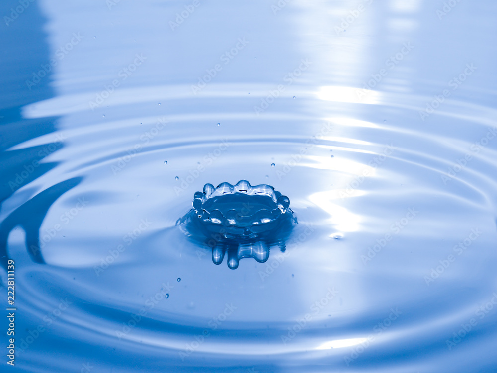 close up drop of water on blue background close up drop of water on blue background
