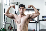Handsome Attractive Asian men doing bodybuilder Front Double Biceps pose in gym feeling so strong and powerful after workout,Bodybuilder Concept