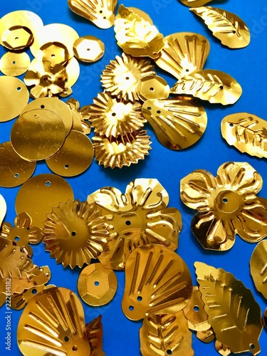 Gold shaped sequins on a blue background