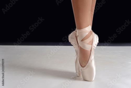 closeup of ballerina feet on pointe in pointe shoes