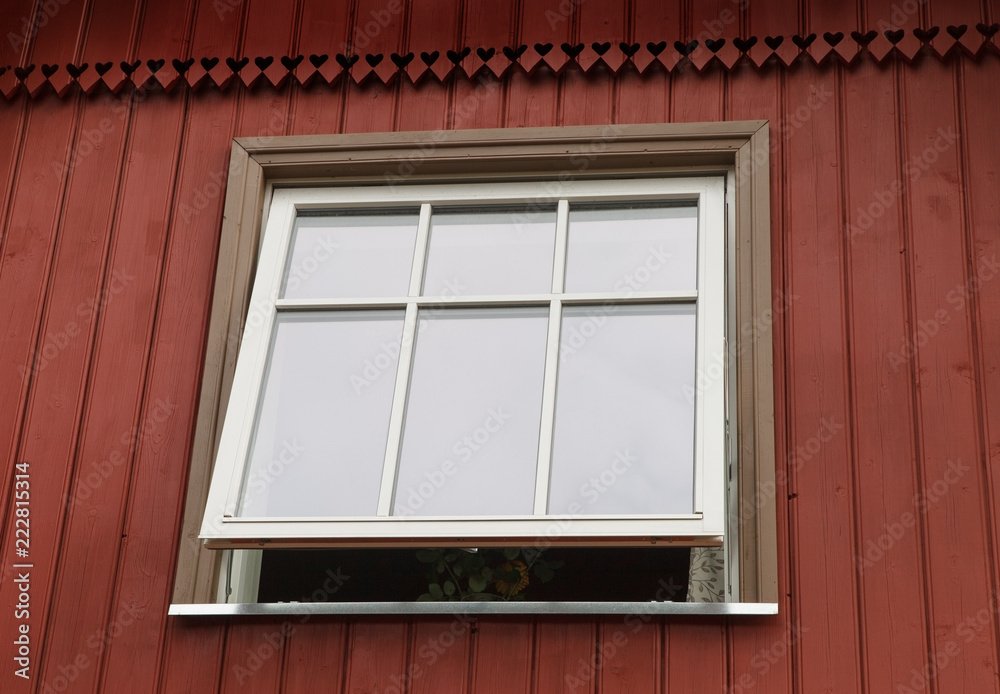 Red cottage with new plastic window.