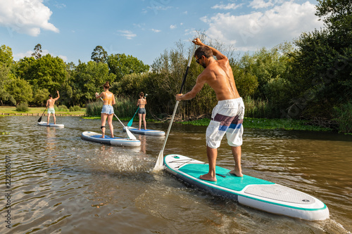 Man and women stand up paddleboarding
