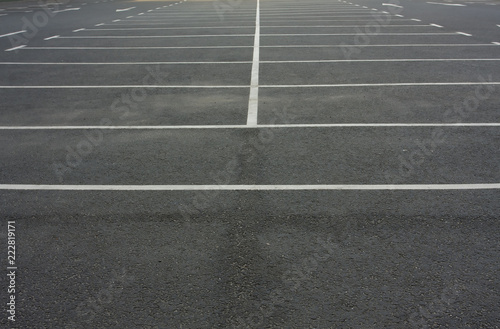 Car parking lot with white lines mark. White markings on asphalt in empty parking lot. © Nadmak