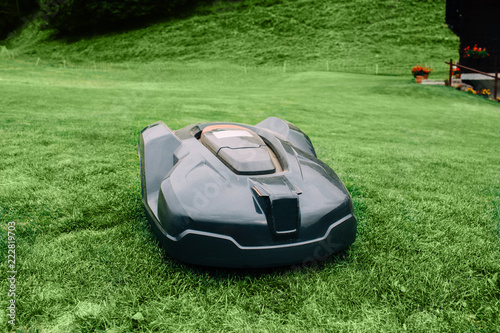 Obraz na plátně Robotic lawn mower on grass, automated lawn mower