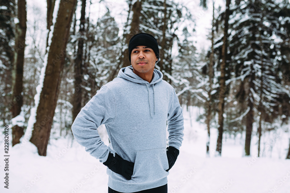 Athlete standing in a forest. Man resting after exercises. Athlete standing in a forest. Man resting after exercises.
