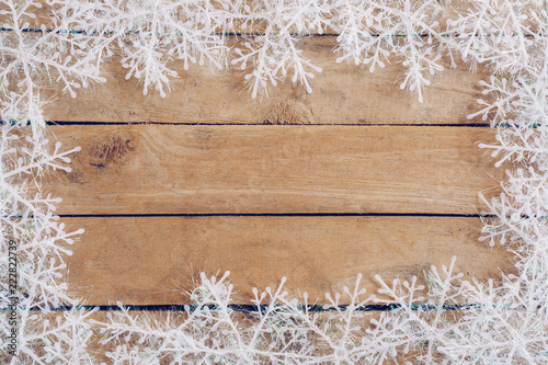 Wooden brown christmas background with snowflakes and christmas decoration.