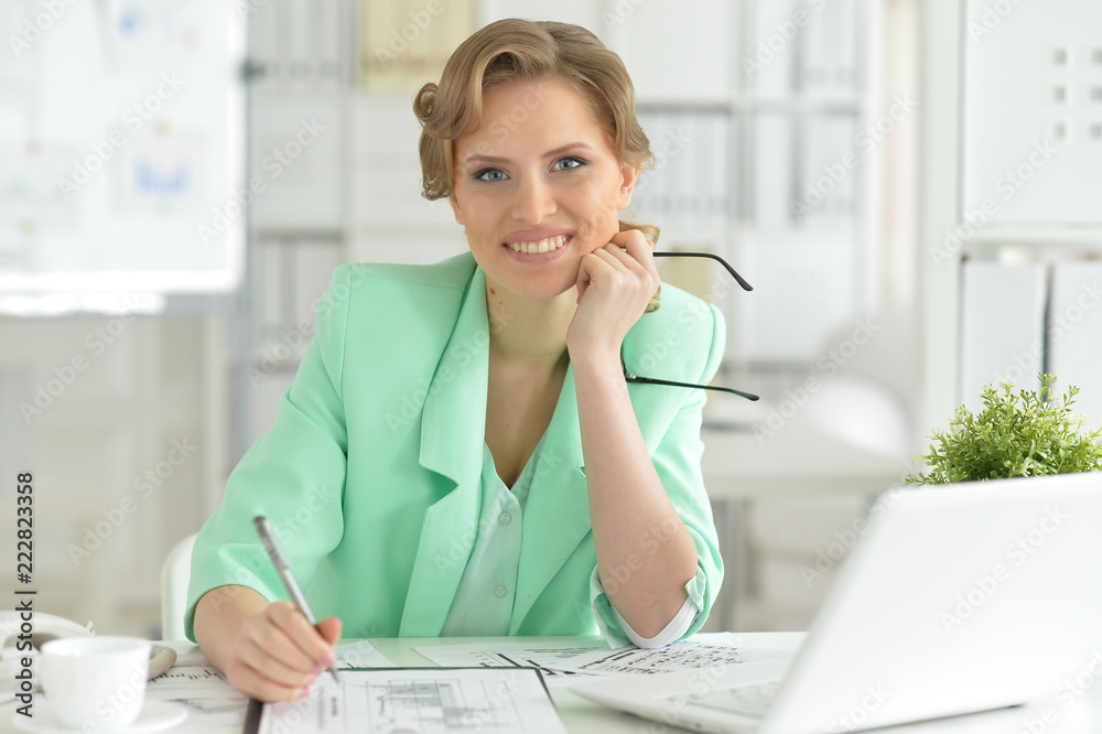 Portrait of Smiling businesswoman with eyeglasses working