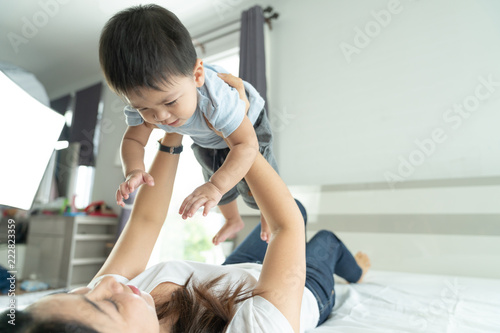 Cuadro en lienzo Portrait of happy laughing baby hugging with cheerful young smiling mother, Scene of pure love and happiness