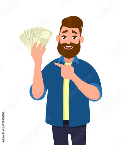 Happy young man holding cash/money/banknotes and pointing his index finger towards that. Financial .money concept. Vector illustration in cartoon style.