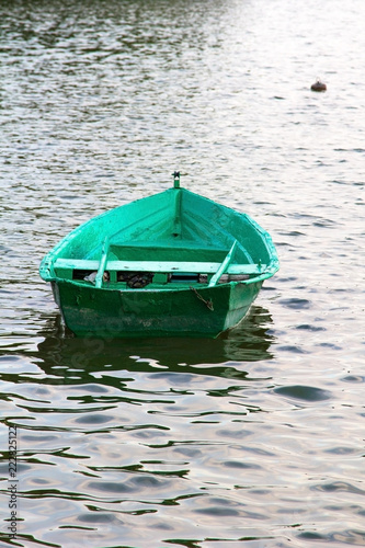 Old green wooden boat on the water, copy space © czarny_bez