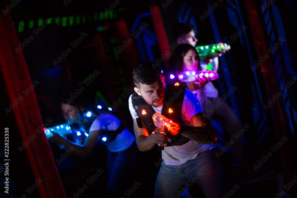 Naklejka premium Emotional guy playing laser tag