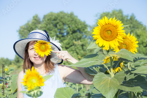 Lady and sunflowers photo