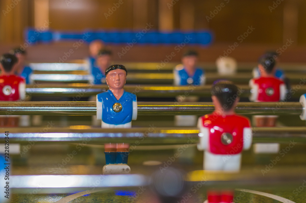 Fototapeta Blue and white uniform table soccer player figurine on foosball board