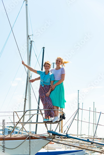 Beautiful and joyful girls, smiling friends, on the deck of a yacht © andov