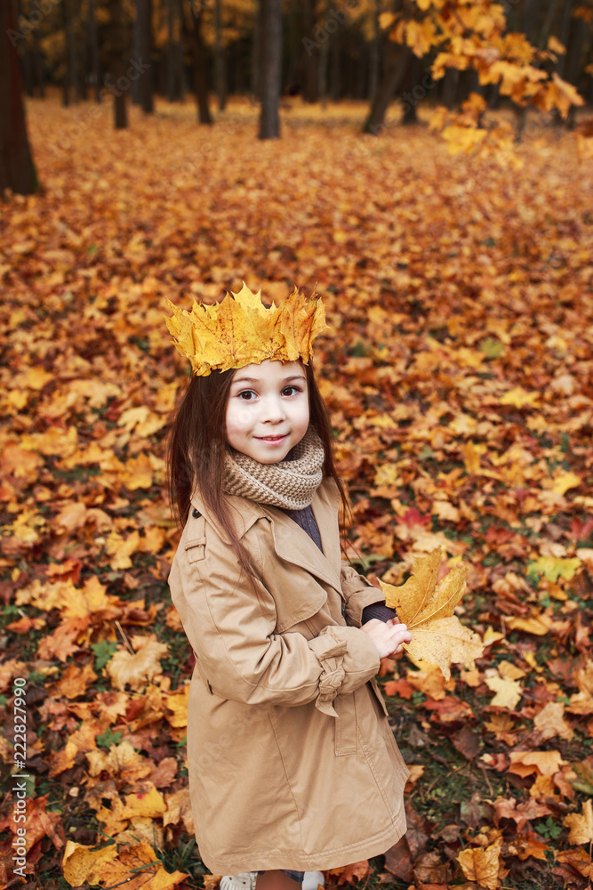 Little girl playing with autumn leaves in the park Little girl playing with autumn leaves in the park