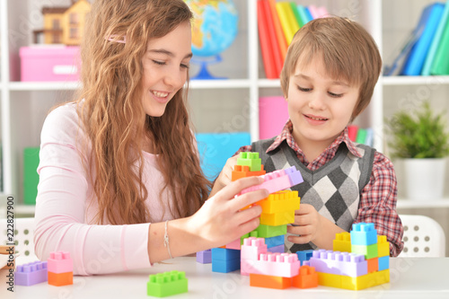 Woman and boy playing blocks game together