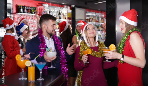 Guy with two girls on new year party in bar