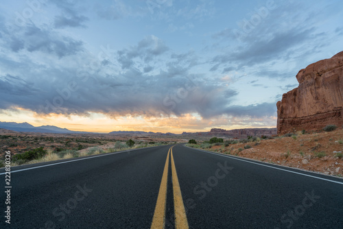 Sunrise over a diminishing road in Arches National Park, the American southwest
